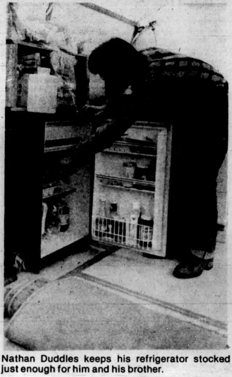 From the original newspaper article, an image showing off the working refirgerator in the house.