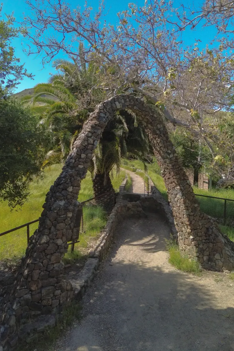 The stone Entry Arch beside the canyon path