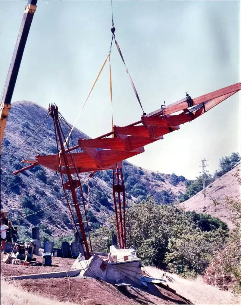 A crane lowering the deck into place during construction.