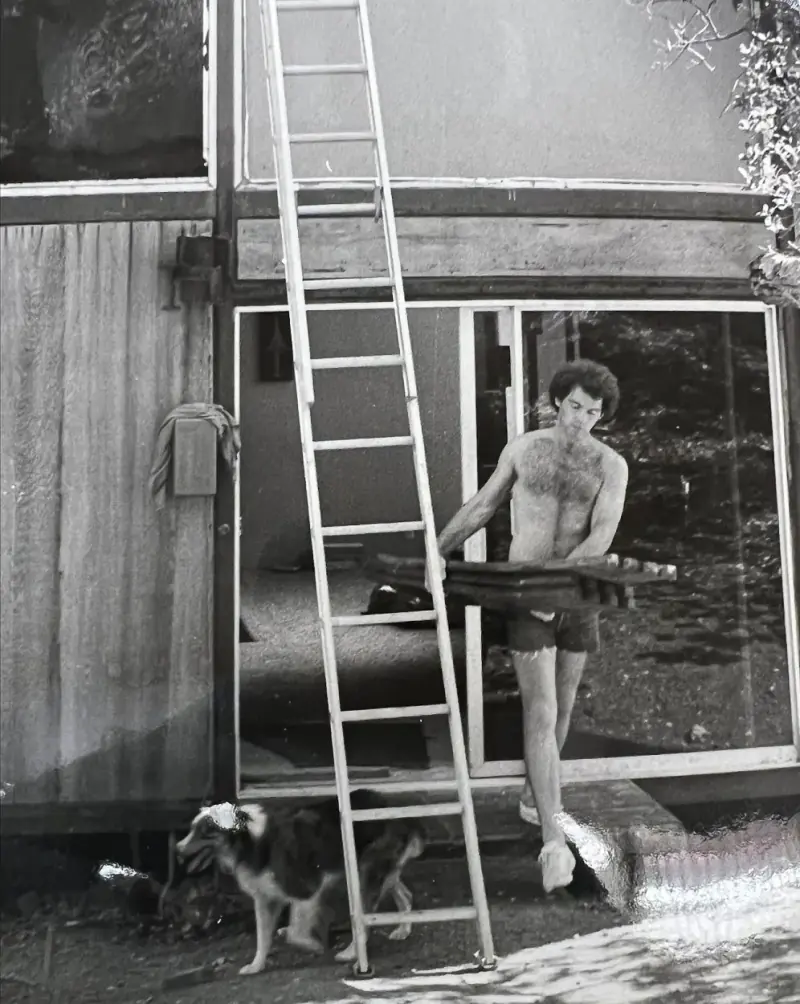 Student and dog seen doing interior work on the modular house.