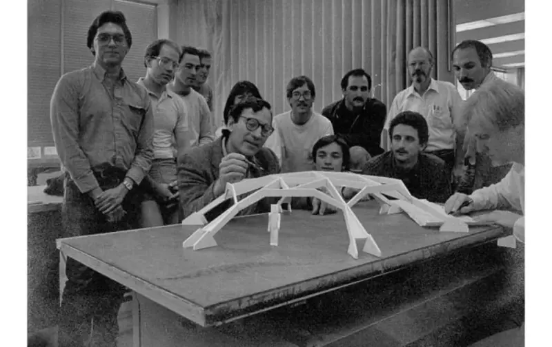 Students and faculty examining a pavilion model prior to construction.
