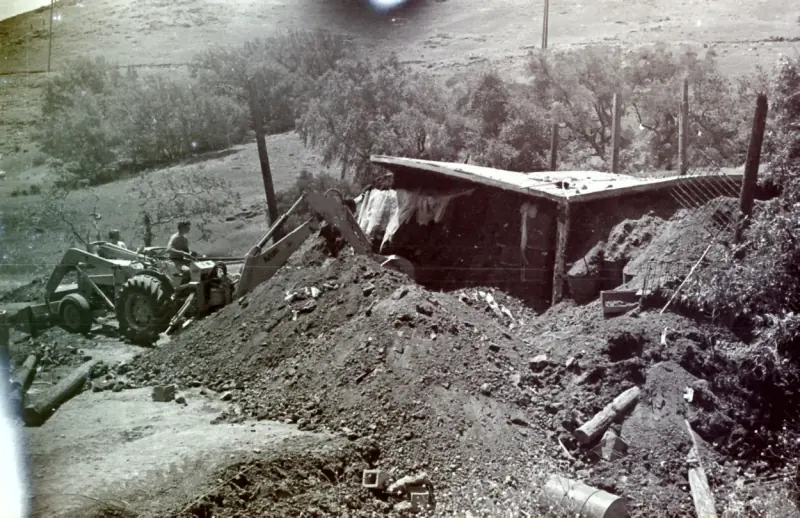 Workers carving out nearby earth during the restroom project.