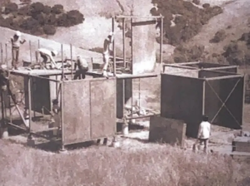 Historical photo of the initial stick structure under construction.