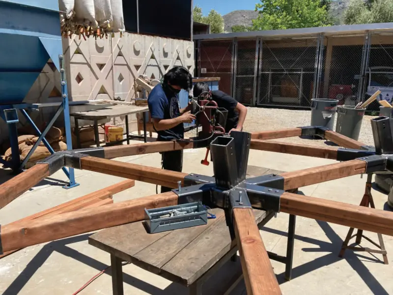 Students assembling the structure in the architecture courtyard.