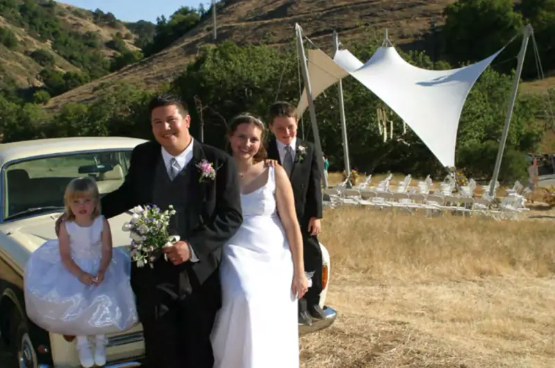 A wedding photo with the ceremony setup in the background, July 2003