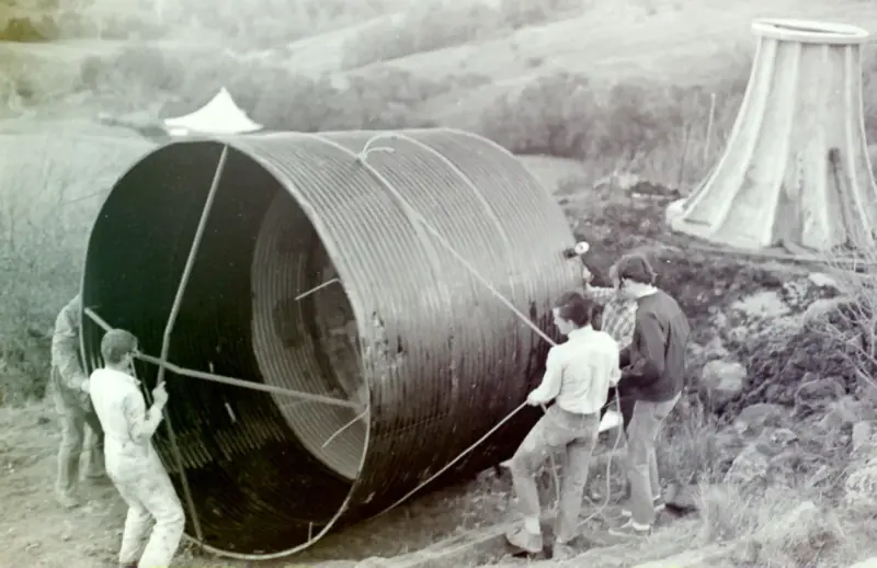 Students putting the tanks into place for a larger water storage system.